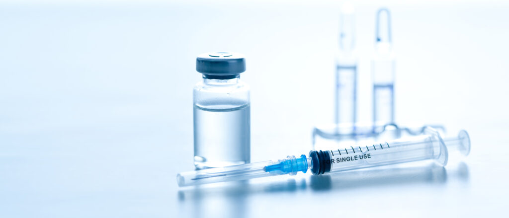 白い背景に置かれた製剤と注射器